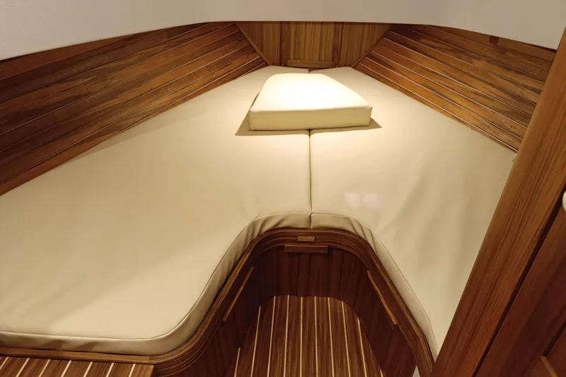 Slide: The Image of Luxurious cabin interior of 2025 Targa 37 boat with wooden paneling and cushioned bed. - 44