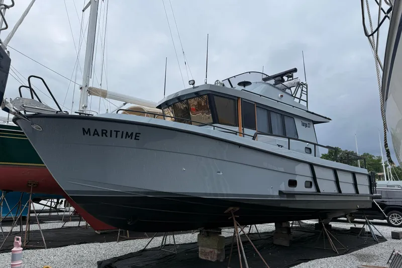 Slide: The Image of 2025 Targa 37 boat named "Maritime" on dry dock, overcast sky background. - 50