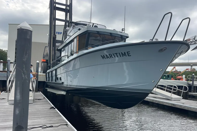 Slide: The Image of 2025 Targa 37 boat named "Maritime" docked at a marina. - 53