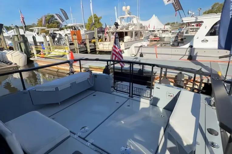 Slide: The Image of 2025 Targa 37 boat docked at marina, showcasing spacious deck and American flag. - 9