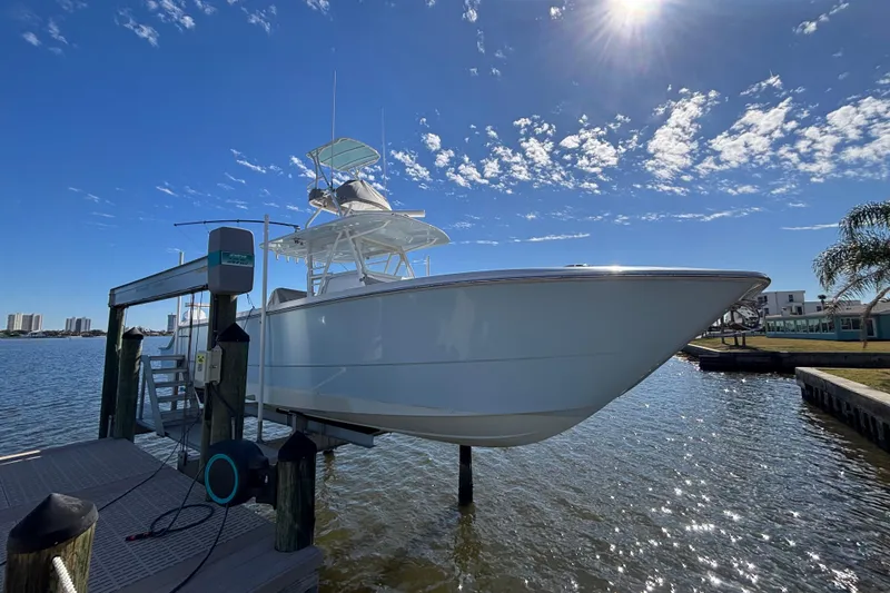 The Image of 2021 Invincible 35 Catamaran on lift under sunny sky, dockside view. - 1