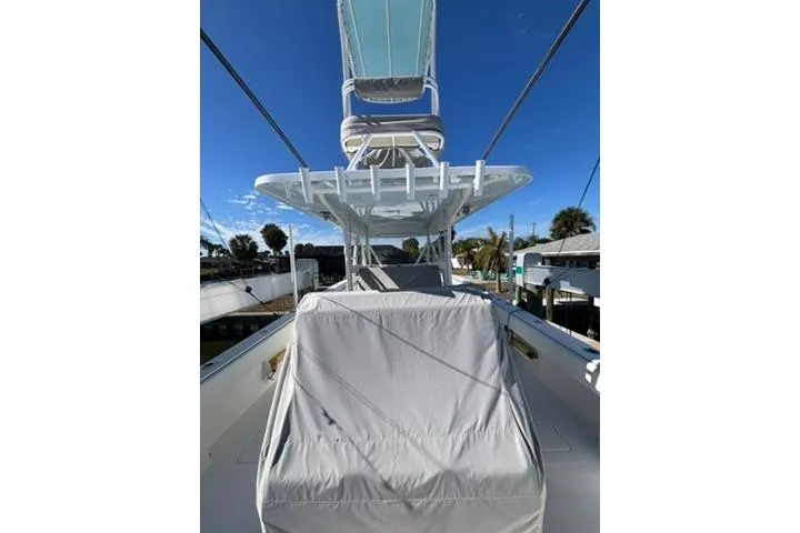 Slide: The Image of 2021 Invincible 35 Catamaran with covered seating and clear blue sky background. - 11