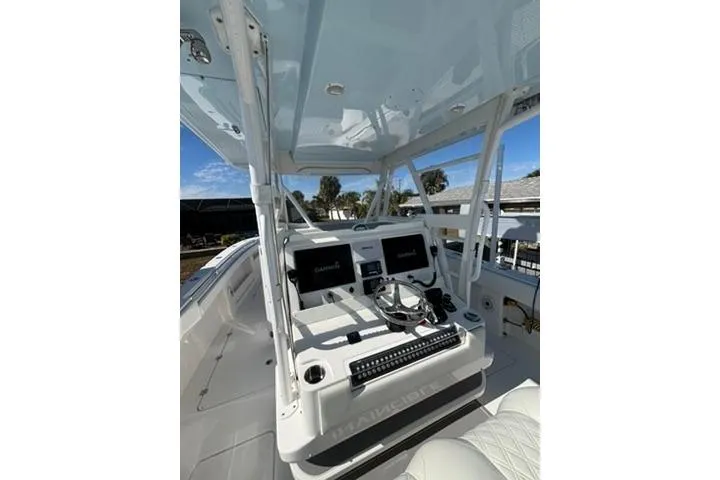 Slide: The Image of 2021 Invincible 35 Catamaran helm with dual screens and steering wheel. - 12