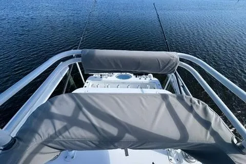 Slide: The Image of 2021 Invincible 35 Catamaran helm view with fishing rods on calm water. - 13