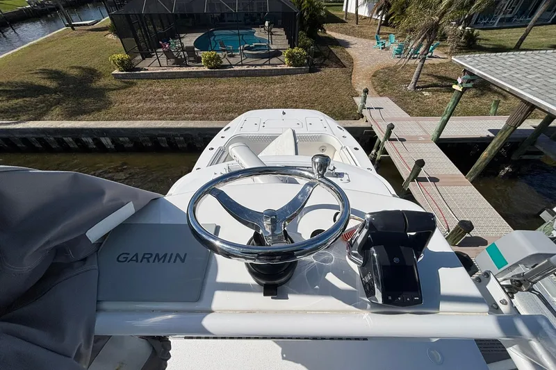 Slide: The Image of 2021 Invincible 35 Catamaran helm with Garmin system, docked near waterfront property. - 14