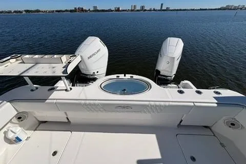 Slide: The Image of 2021 Invincible 35 Catamaran with dual Mercury engines on calm water. - 4