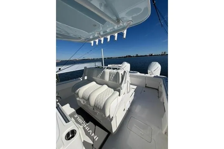Slide: The Image of 2021 Invincible 35 Catamaran with luxurious seating, docked on a sunny day. - 5