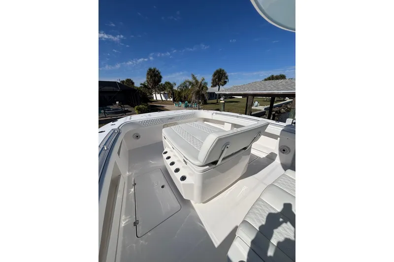 Slide: The Image of 2021 Invincible 35 Catamaran interior with seating, under a clear blue sky. - 7