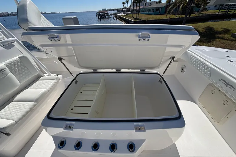Slide: The Image of Open storage compartment on 2021 Invincible 35 Catamaran, featuring sleek seating and waterfront view. - 9