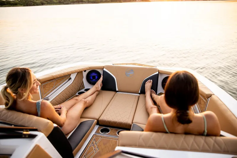 Slide: The Image of Manufacturer Provided Image: 2023 Tigé 24RZX boat interior with two women relaxing on tan seats. - 14