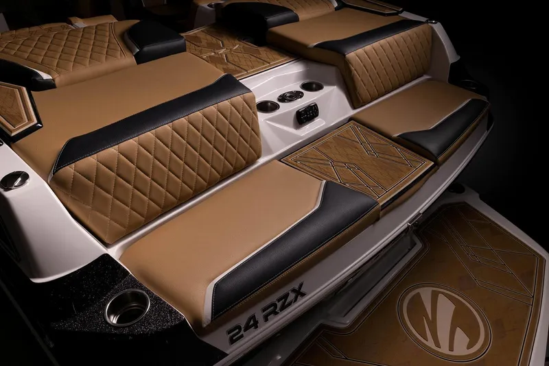 Slide: The Image of Manufacturer Provided Image: 2023 Tigé 24RZX boat interior with luxurious tan and black diamond-stitched seating. - 30