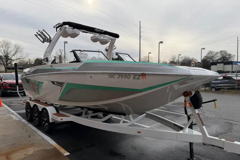 Slide: The Image of 2023 Tigé 24RZX boat on trailer, parked outdoors, overcast sky. - 5