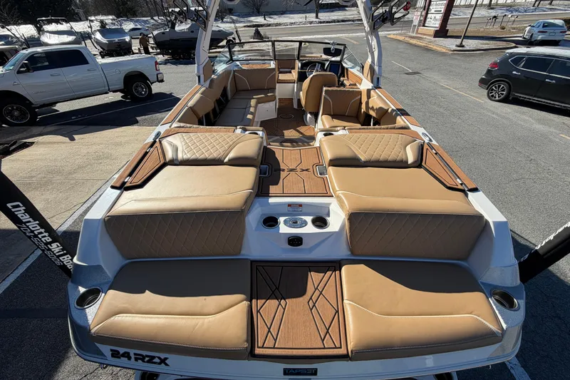 Slide: The Image of 2023 Tigé 24RZX boat with luxurious tan seating and spacious deck layout. - 7