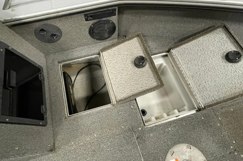 Slide: The Image of 2007 Lund 1900 Pro-V IFS/SE boat storage compartments with open hatches. - 12