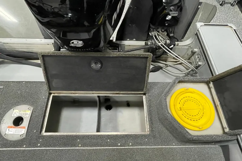 Slide: The Image of 2007 Lund 1900 Pro-V IFS/SE boat interior with open storage compartments and engine view. - 15