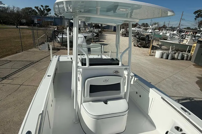 Slide: The Image of 2016 Crevalle 26 Bay boat with T-top and seating, docked in a marina. - 11