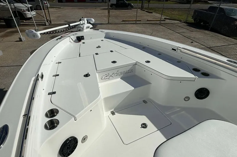 Slide: The Image of 2016 Crevalle 26 Bay boat deck with storage compartments and cup holders. - 12