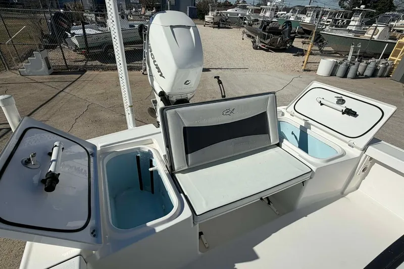 Slide: The Image of 2016 Crevalle 26 Bay boat with open storage compartments and Mercury engine. - 14