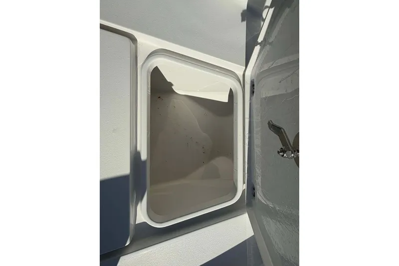 Slide: The Image of Open storage compartment on a 2016 Crevalle 26 Bay boat. - 19