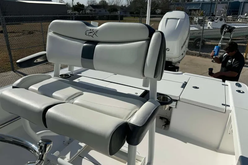 Slide: The Image of 2016 Crevalle 26 Bay boat interior with cushioned seating and outboard motor. - 22