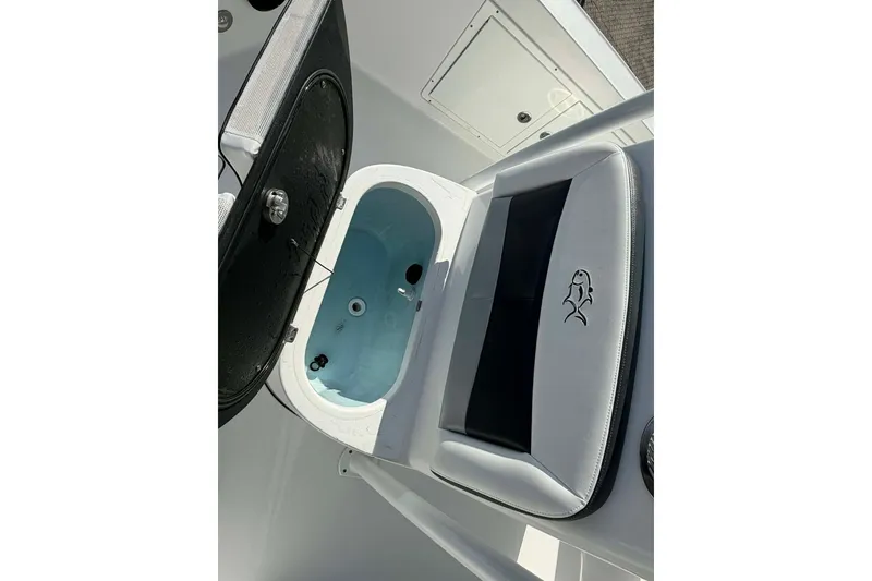 Slide: The Image of 2016 Crevalle 26 Bay boat livewell with open lid and cushioned seat. - 3