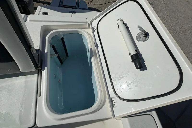 Slide: The Image of Livewell compartment on a 2016 Crevalle 26 Bay boat, open with water inside. - 4