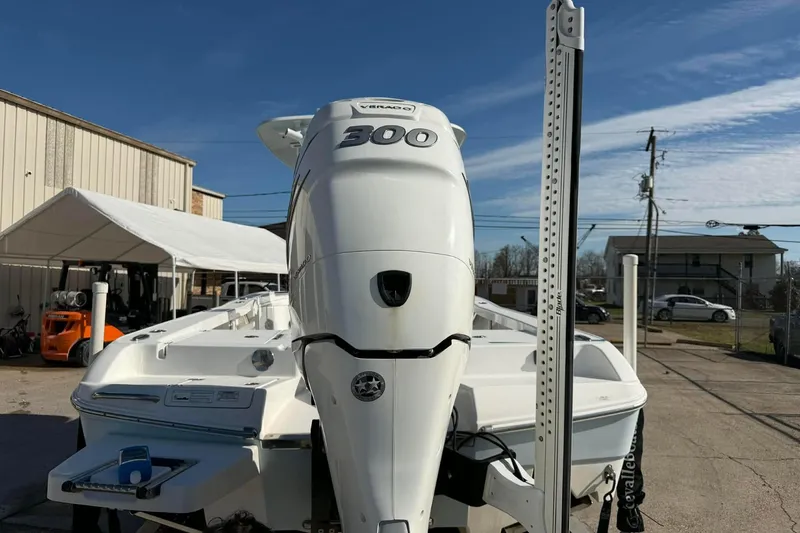 Slide: The Image of 2016 Crevalle 26 Bay boat with powerful 300 horsepower engine, parked outdoors. - 5