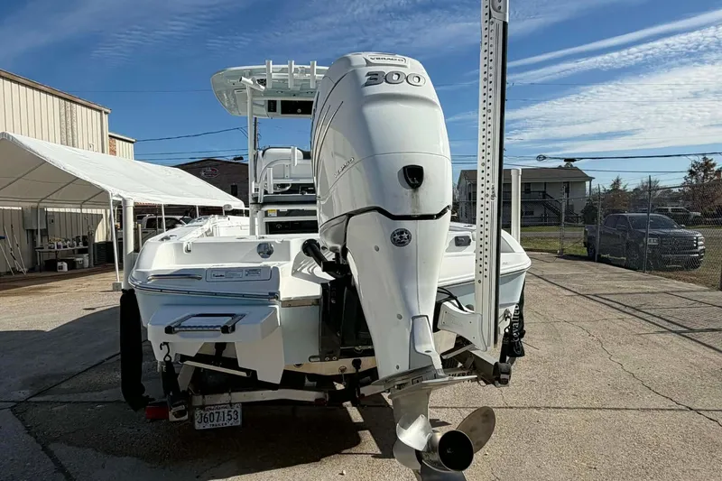 Slide: The Image of 2016 Crevalle 26 Bay boat with powerful outboard motor, parked outdoors. - 6