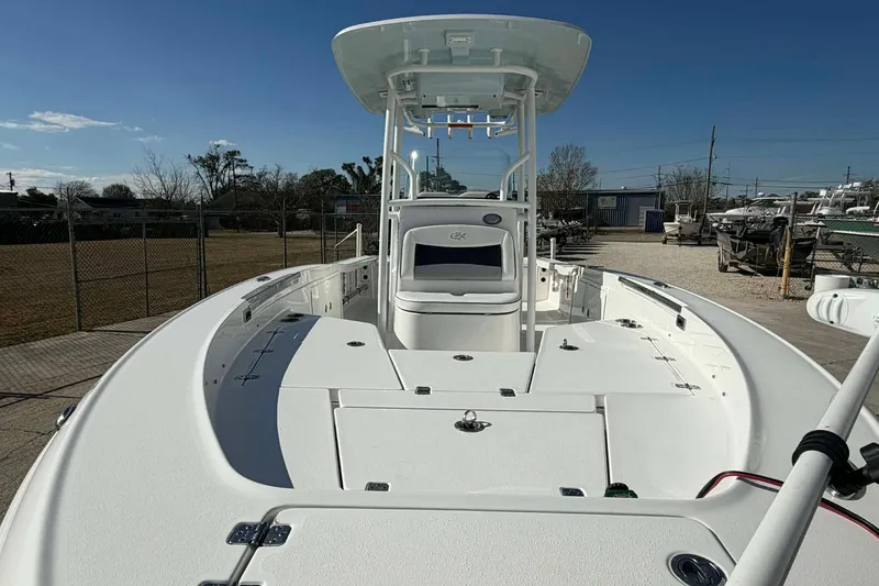 Slide: The Image of 2016 Crevalle 26 Bay boat with spacious deck and T-top under clear blue sky. - 7
