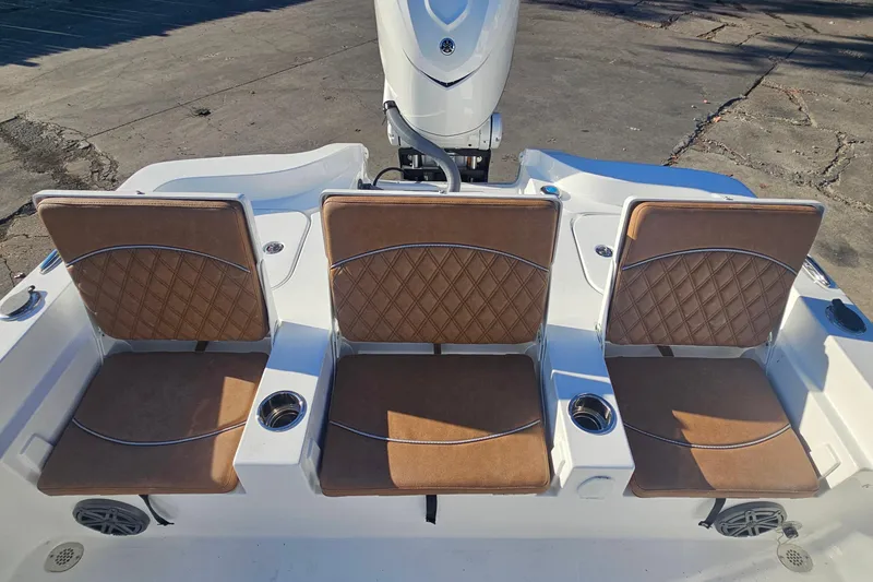 Slide: The Image of 2026 Sea Hunt BX 25 FS boat with three tan cushioned seats and cup holders. - 12