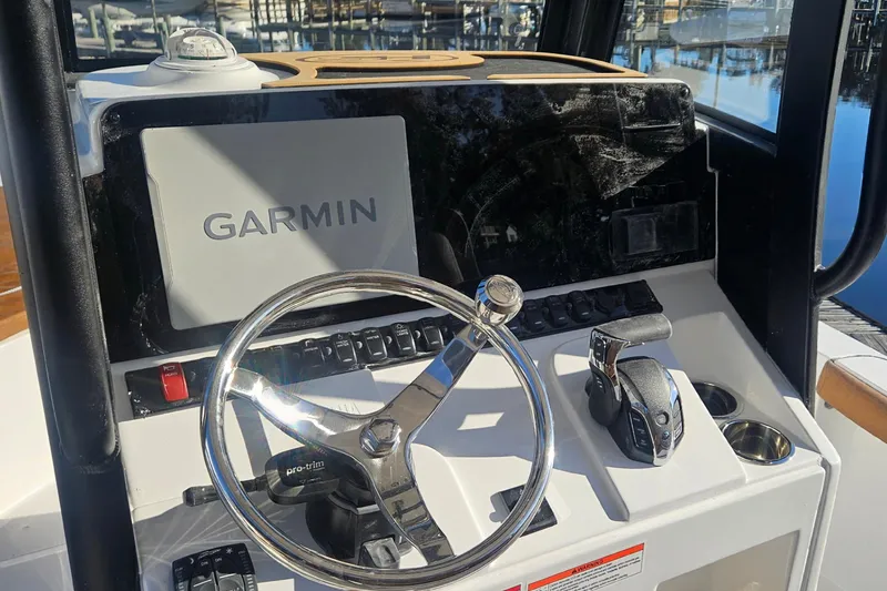Slide: The Image of 2026 Sea Hunt BX 25 FS boat dashboard with Garmin navigation system and steering wheel. - 15