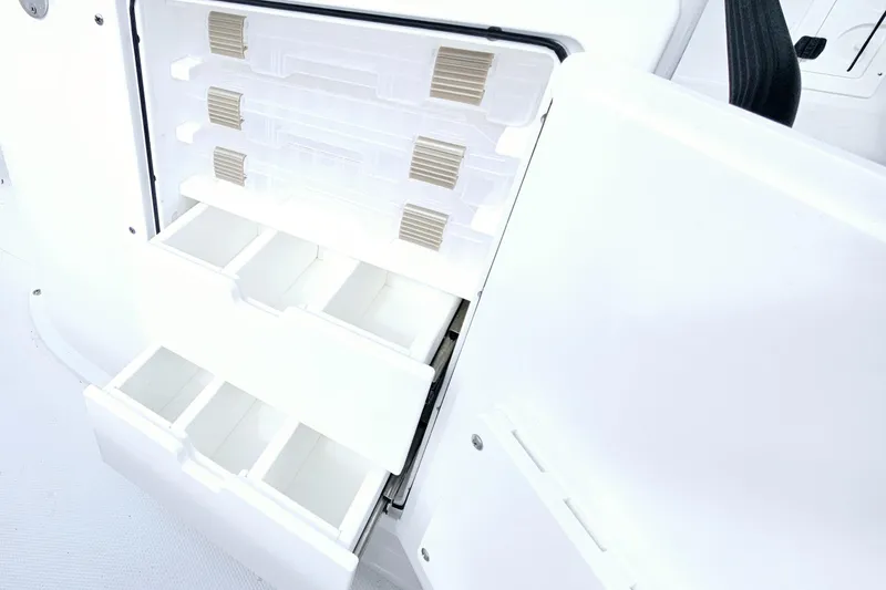 Slide: The Image of Storage compartments on a 2026 Sea Hunt BX 25 FS boat, featuring organized drawers. - 19