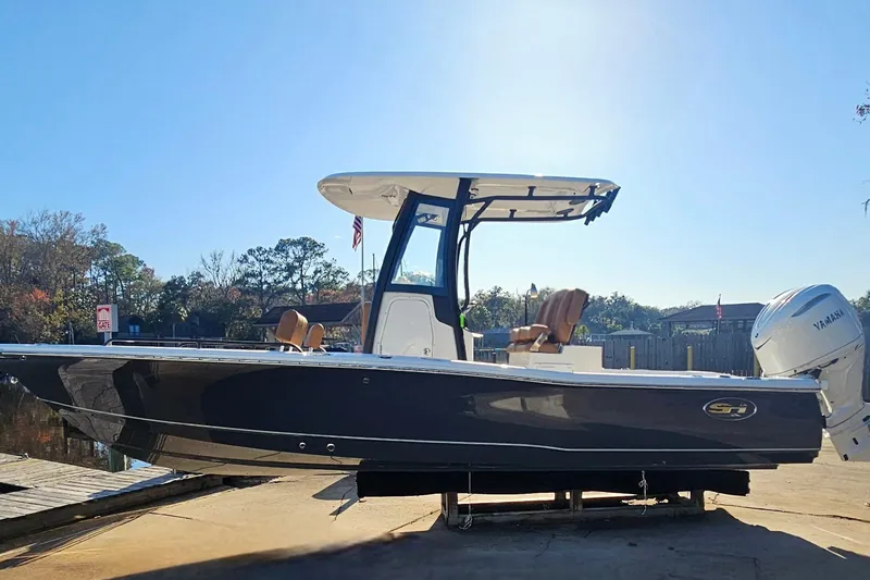 Slide: The Image of 2026 Sea Hunt BX 25 FS boat with Yamaha engine, docked under clear blue sky. - 3