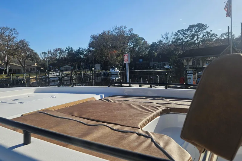 Slide: The Image of 2026 Sea Hunt BX 25 FS boat docked at a marina under clear blue skies. - 8
