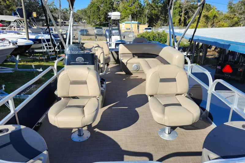 Slide: The Image of 2023 Sun Tracker Bass Buggy 18 DLX pontoon boat with beige seating and spacious deck. - 12