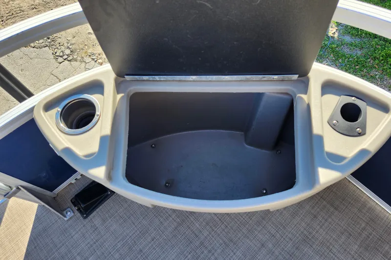 Slide: The Image of 2023 Sun Tracker Bass Buggy 18 DLX storage compartment with cup holders. - 14