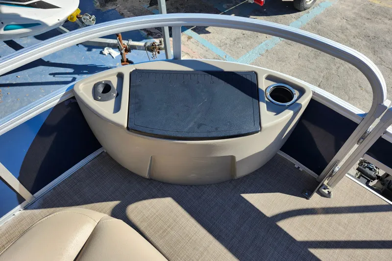 Slide: The Image of 2023 Sun Tracker Bass Buggy 18 DLX boat interior with cup holders and storage. - 15
