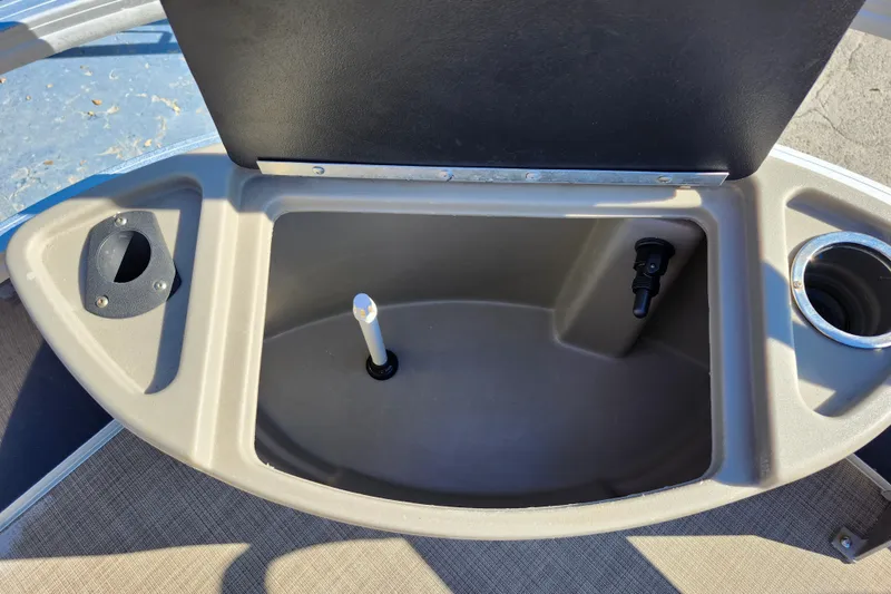 Slide: The Image of 2023 Sun Tracker Bass Buggy 18 DLX storage compartment with cup holder and accessory port. - 16