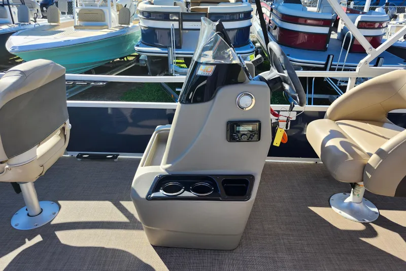 Slide: The Image of 2023 Sun Tracker Bass Buggy 18 DLX pontoon boat interior with steering console and seating. - 19