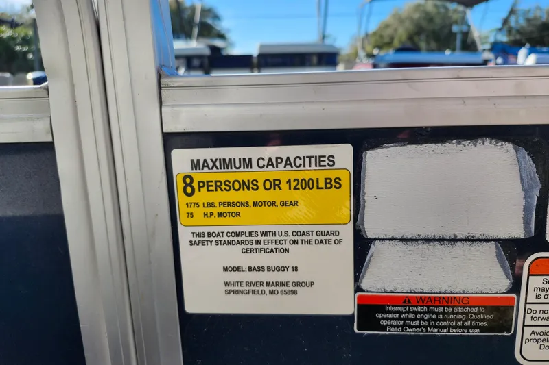 Slide: The Image of 2023 Sun Tracker Bass Buggy 18 DLX capacity label, 8 persons or 1200 lbs, 75 HP motor. - 21