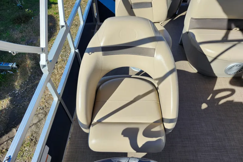 Slide: The Image of 2023 Sun Tracker Bass Buggy 18 DLX boat seat, beige upholstery, outdoor setting. - 22