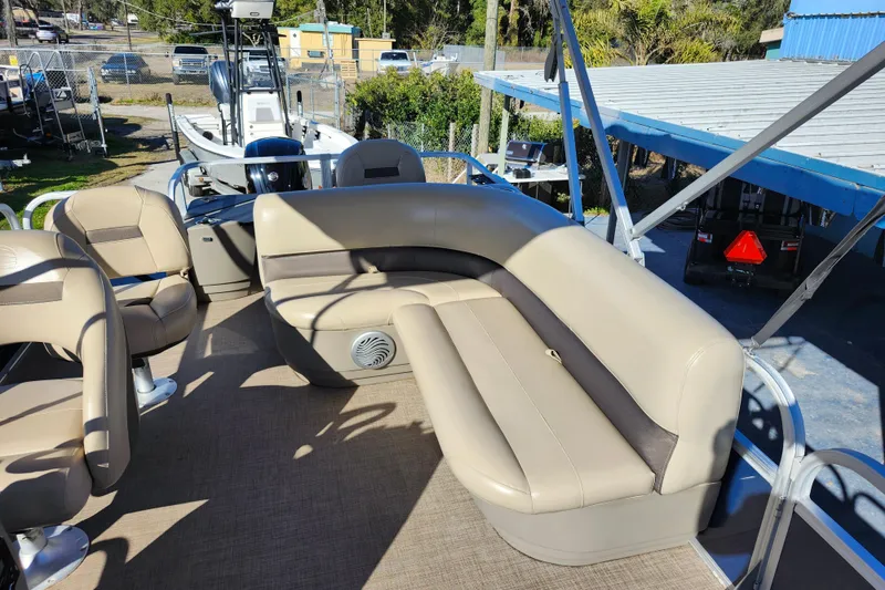 Slide: The Image of 2023 Sun Tracker Bass Buggy 18 DLX pontoon boat with beige seating and spacious deck. - 23
