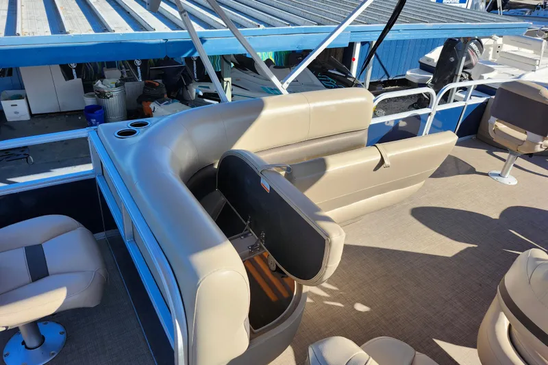 Slide: The Image of 2023 Sun Tracker Bass Buggy 18 DLX pontoon boat interior with seating and storage. - 25