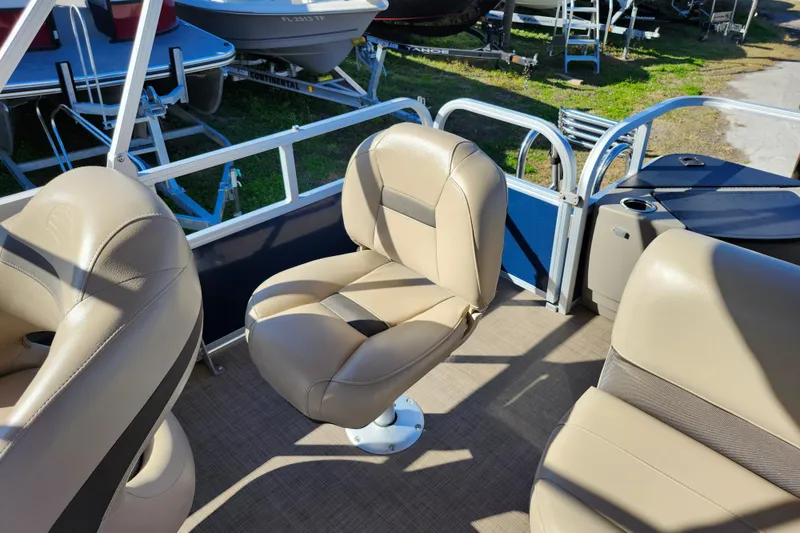 Slide: The Image of 2023 Sun Tracker Bass Buggy 18 DLX interior with beige seating and console. - 28