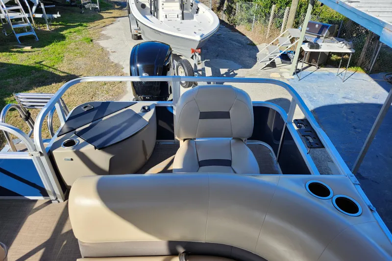 Slide: The Image of 2023 Sun Tracker Bass Buggy 18 DLX pontoon boat interior with seating and cup holders. - 29