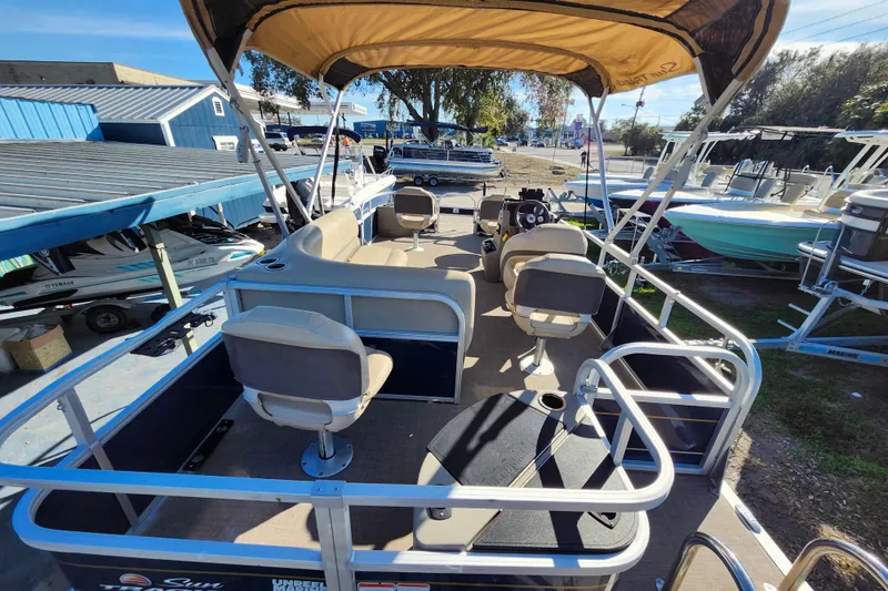 Slide: The Image of 2023 Sun Tracker Bass Buggy 18 DLX pontoon boat with canopy and seating, docked outdoors. - 37
