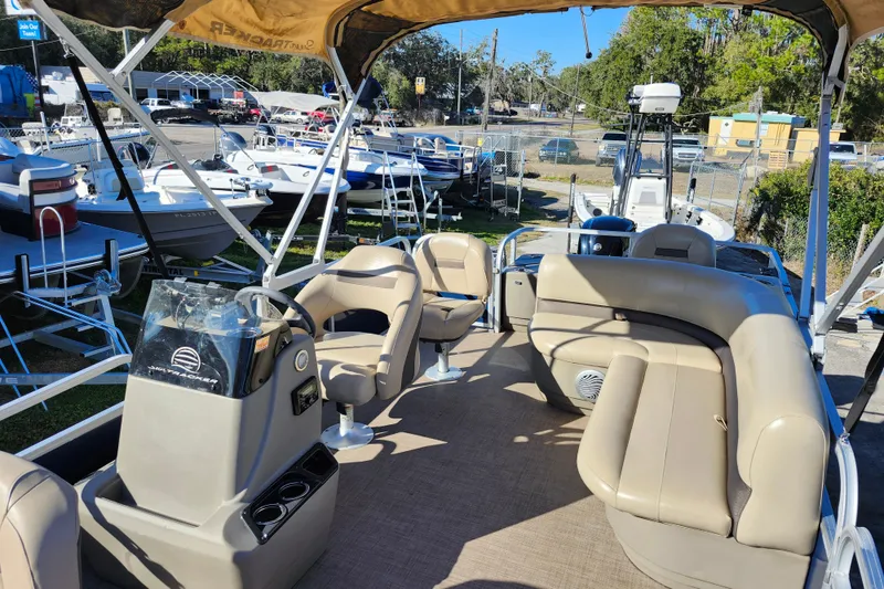 Slide: The Image of 2023 Sun Tracker Bass Buggy 18 DLX pontoon boat with beige seating and canopy. - 40
