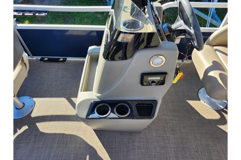 Slide: The Image of 2023 Sun Tracker Bass Buggy 18 DLX boat console with steering wheel and cup holders. - 43