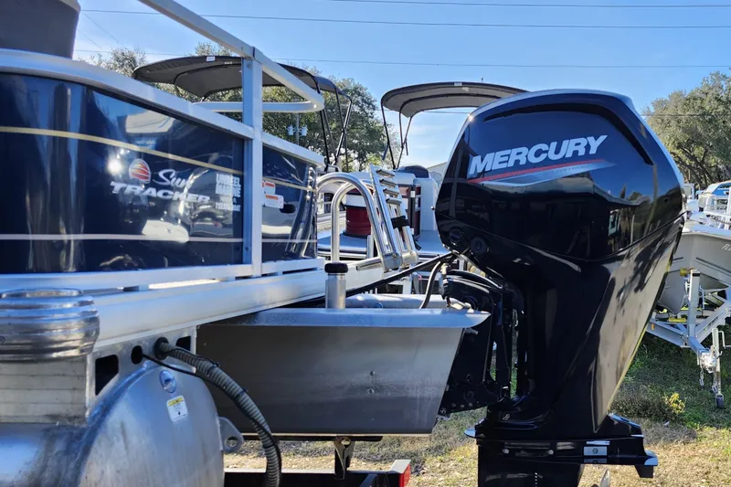 Slide: The Image of 2023 Sun Tracker Bass Buggy 18 DLX with Mercury outboard motor, side view. - 5