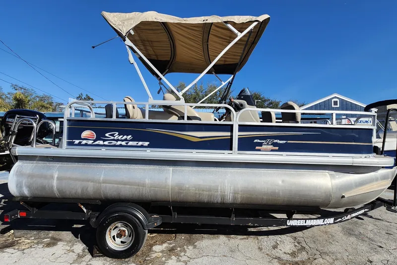 Slide: The Image of 2023 Sun Tracker Bass Buggy 18 DLX pontoon boat with canopy on trailer. - 8